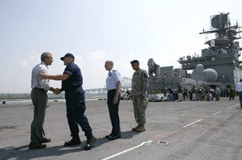 President George W. Bush is greeted
                              by U.S. Coast Guard