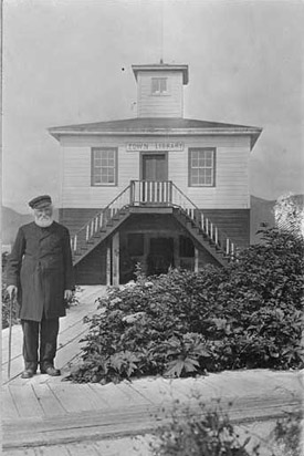 Father William Duncan in front of
                              town library