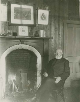 William Duncan sitting by his
                                fireplace
